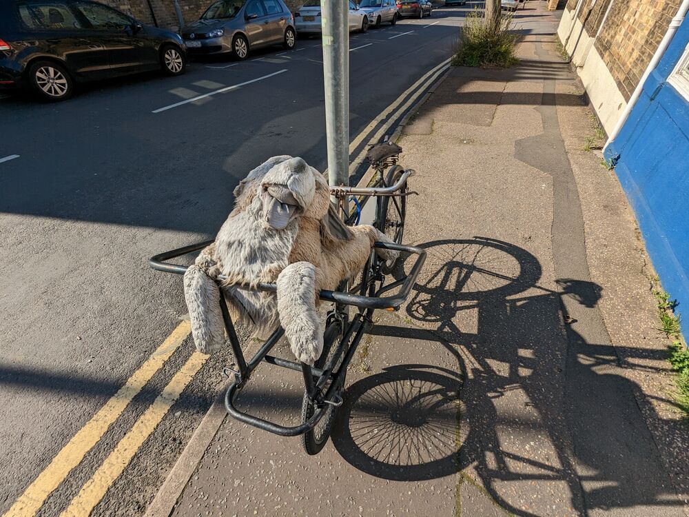 A large stuffed bear toy lying in a bike