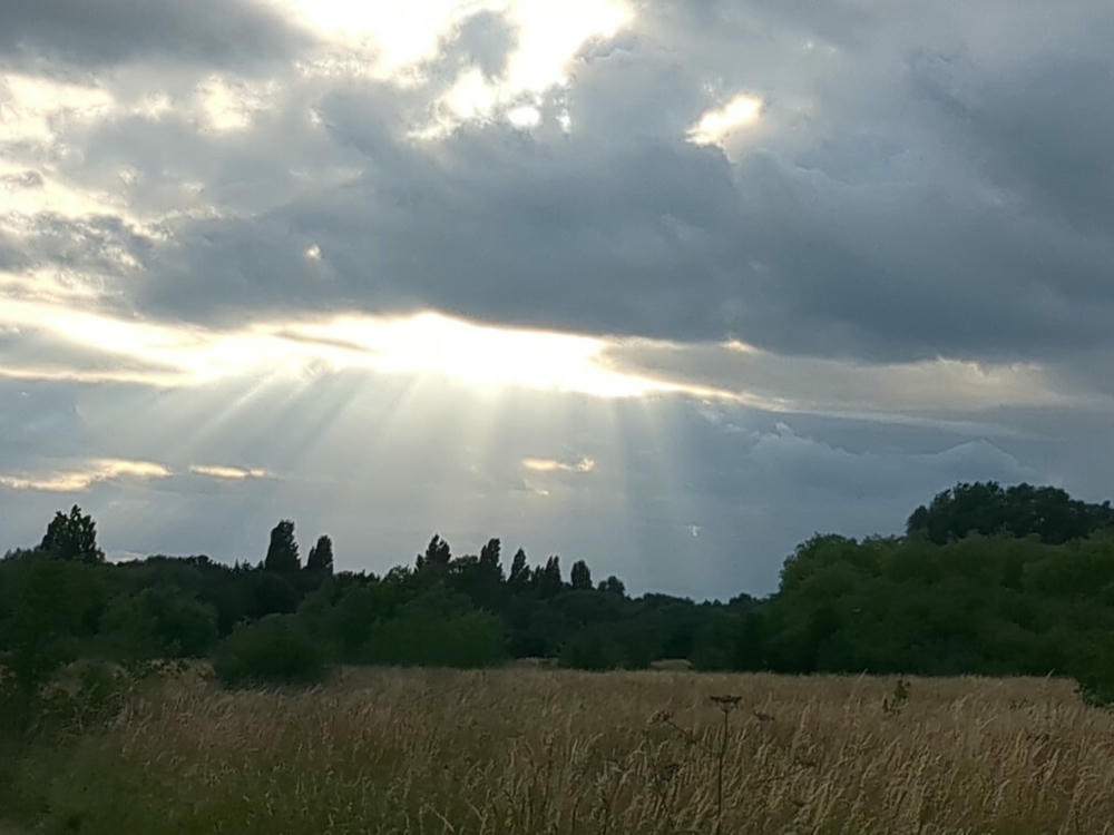 some godrays shining through a partly clouded sky